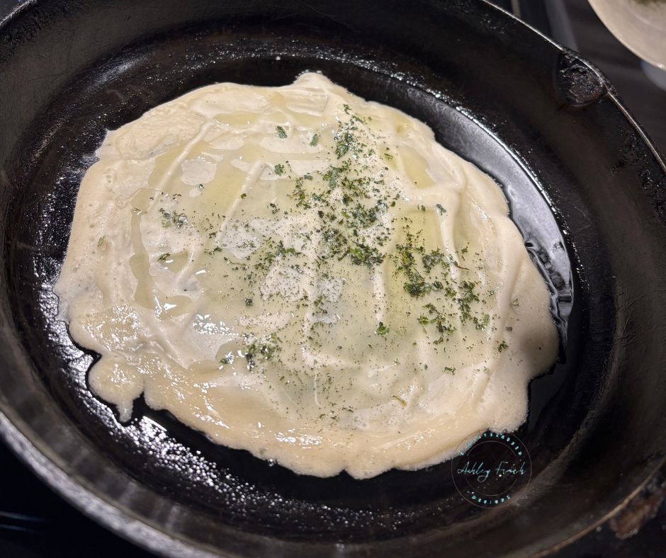 Fresh herbs sprinkled on discard base before baking