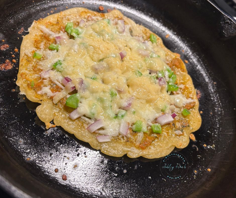 Adding cheese and veggies to baked sourdough crust