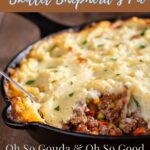 warm and hearty skillet shepherd’s pie topped with golden mashed potatoes and smoked gouda, served in a black cast iron pan with ground beef, peas, and carrots, rustic comfort food styled for SimplyBlessedDesignz