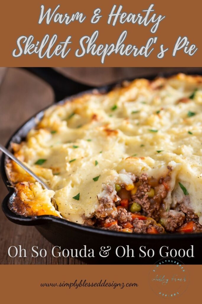 warm and hearty skillet shepherd’s pie topped with golden mashed potatoes and smoked gouda, served in a black cast iron pan with ground beef, peas, and carrots, rustic comfort food styled for SimplyBlessedDesignz