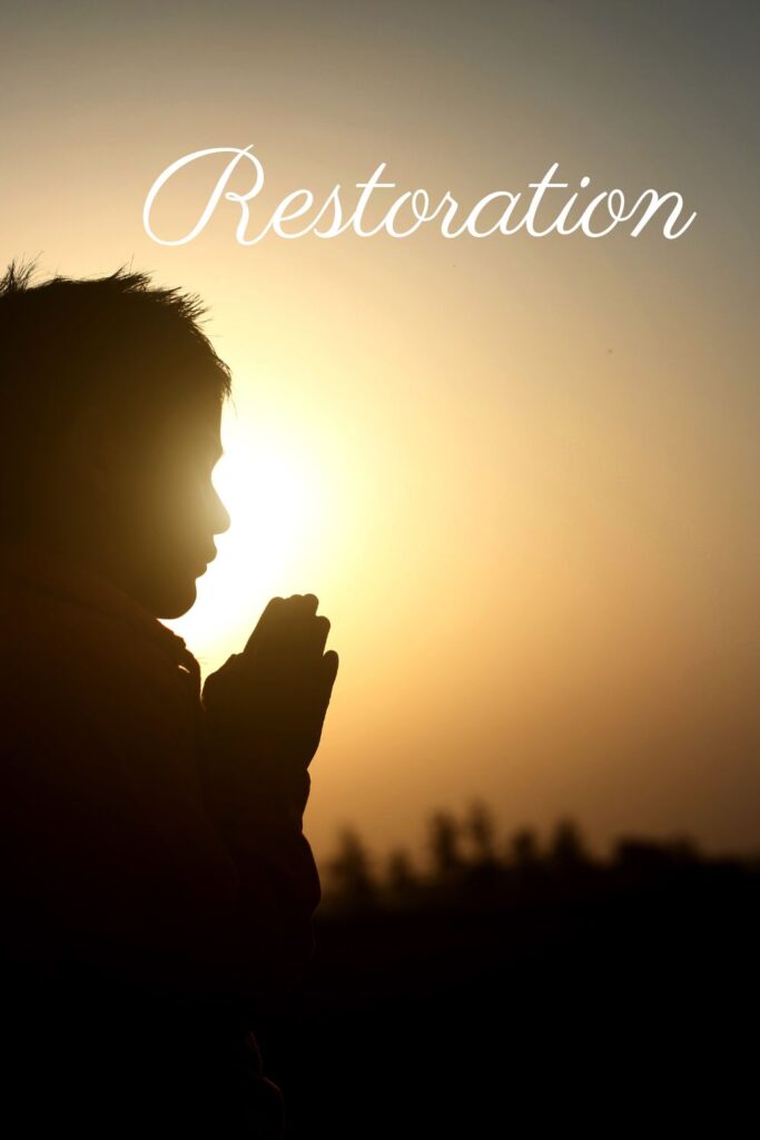 Silhouette of a person praying at sunrise with the word “Restoration” overlayed, symbolizing Job’s restoration and deeper faith.
