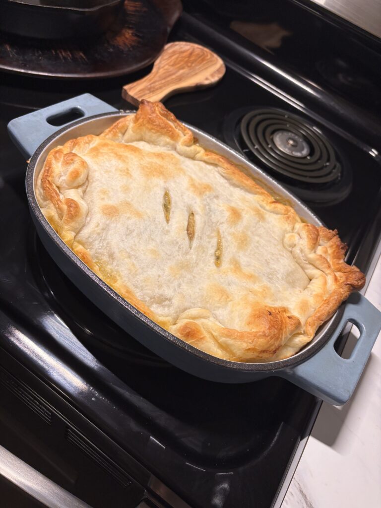 Quick and easy chicken pot pie with puff pastry baked in a cast iron skillet